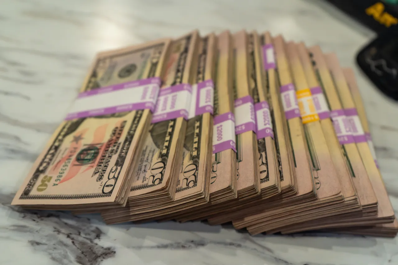 Stacks of $25,000 in cash on the billiard table