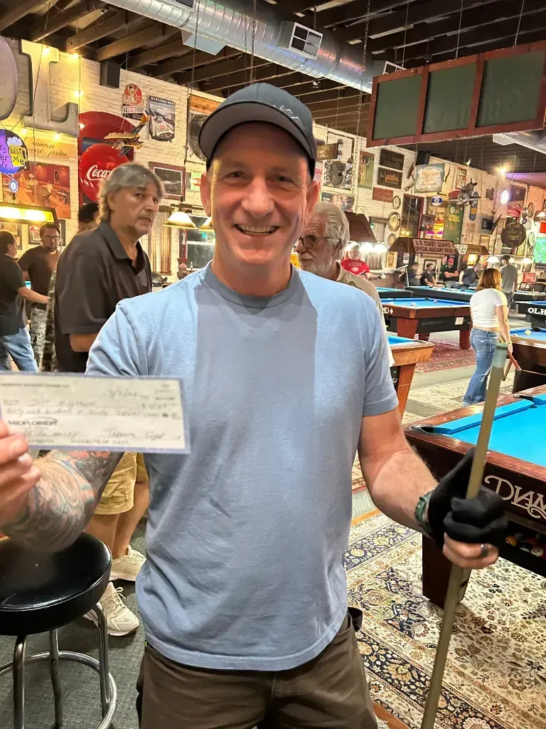 Jeff holding his cue and $4,167 championship winning check