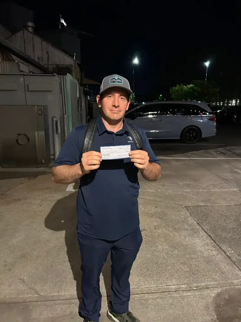 John displaying his $4,167 championship winning check